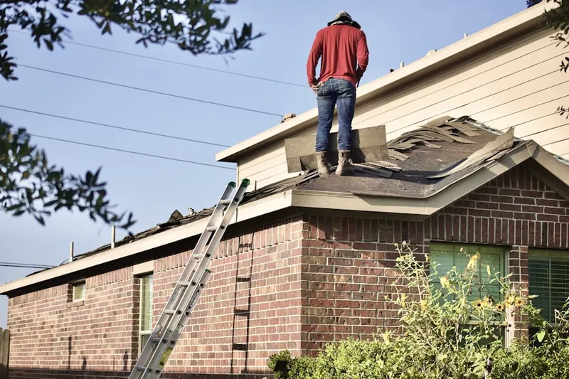 Professional roofer working on a residential roof in Westbury